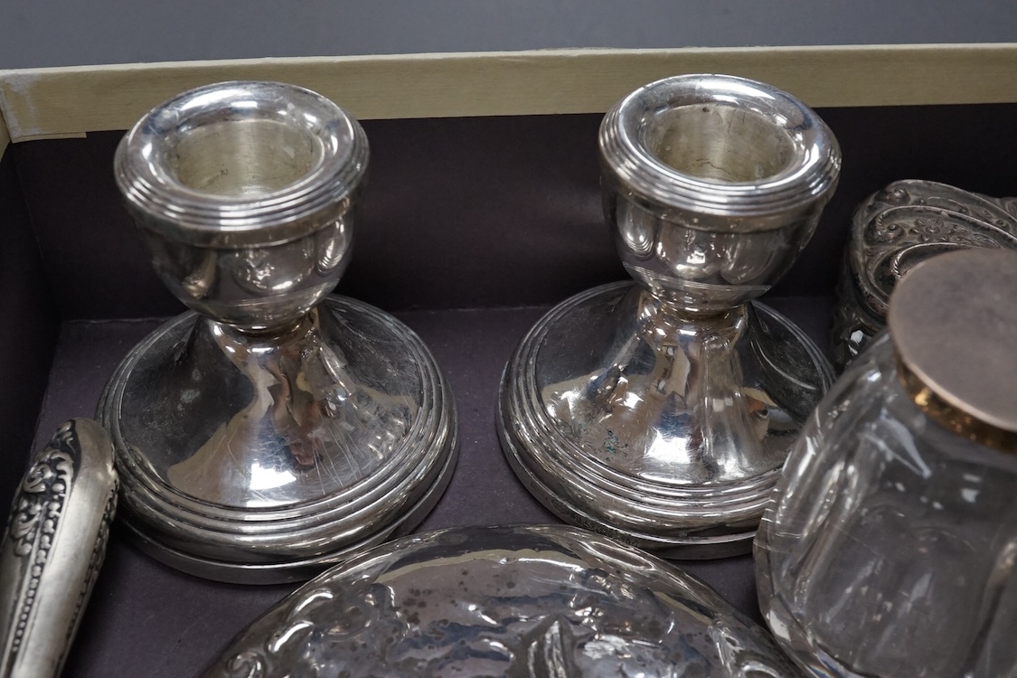 Two silver mounted hand mirrors including Reynold's Angels, Chester, 1899, 26.7cm, together with four silver mounted dressing table implements, a pair of silver mounted dwarf candlesticks and four assorted silver mounted